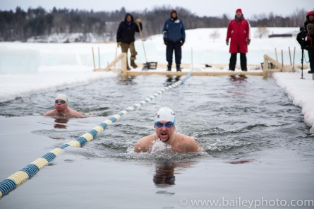 men swimming in cold water
